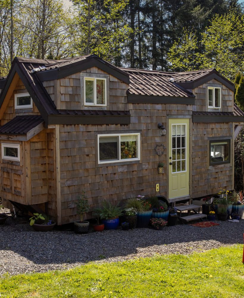 Cute little tiny home with wood paneling and privacy for a minim